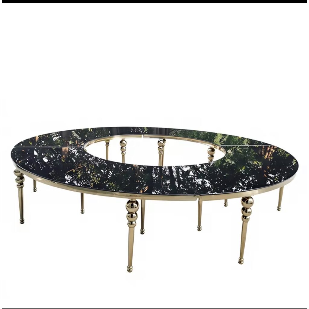 Luxury circular event table with black smoked glass surface and gold metallic legs.