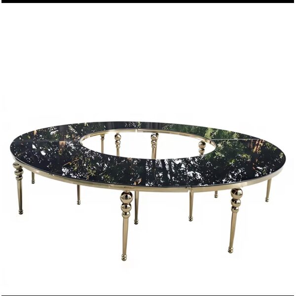 Luxury circular event table with black smoked glass surface and gold metallic legs.